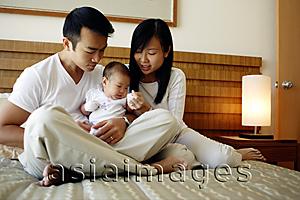 Asia Images Group - Father and mother holding baby girl