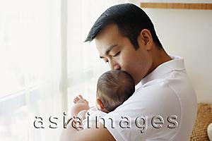 Asia Images Group - Father carrying baby daughter