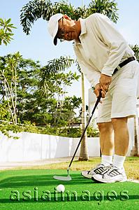 Asia Images Group - Mature man holding golf club