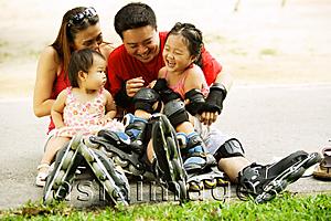 Asia Images Group - Family with two children sitting on ground, bonding