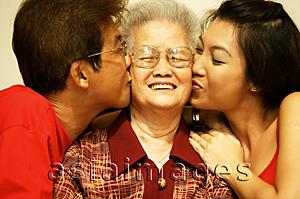 Asia Images Group - Three generation family, son and granddaughter kissing grandmother