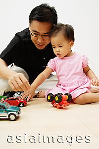 Asia Images Group - Father and daughter playing with cars
