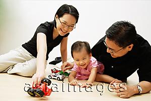 Asia Images Group - Father, mother and daughter playing with cars