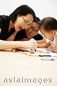 Asia Images Group - Family with one child drawing with crayons