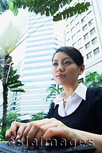 Asia Images Group - Business woman using laptop, low angle view