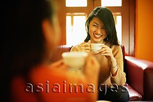 Asia Images Group - Two young women drinking tea