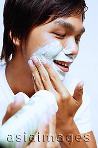 Asia Images Group - Young man applying shaving foam on face