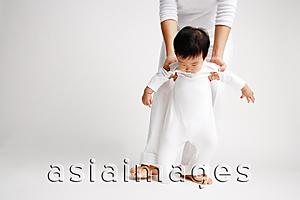 Asia Images Group - Baby boy standing, being supported by mother from behind