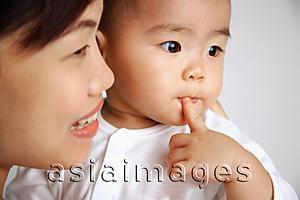 Asia Images Group - Mother with baby, head shot, looking away