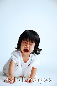Asia Images Group - Baby girl crawling on floor, crying, mouth open