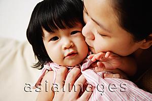 Asia Images Group - Mother kissing baby girl on cheek
