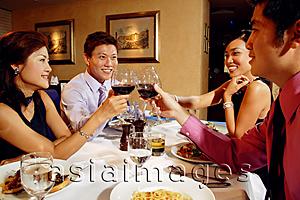 Asia Images Group - Couples in restaurant, toasting with wine glasses