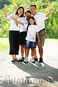 Asia Images Group - Family standing together, smiling, waving