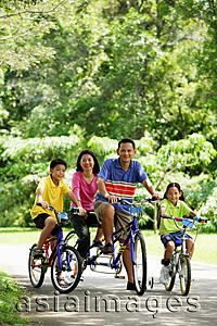 Asia Images Group - Family in park, riding bicycles