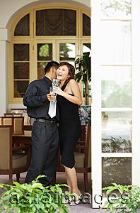 Asia Images Group - Couple at doorway, woman laughing