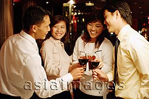 Asia Images Group - Young executives standing, toasting with wine