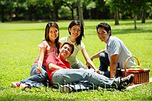 Asia Images Group - Young adults sitting in park, looking at camera