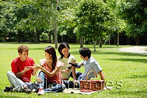 Asia Images Group - Young adults having picnic in park