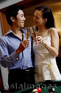 Asia Images Group - Couple standing side by side, toasting with champagne glasses