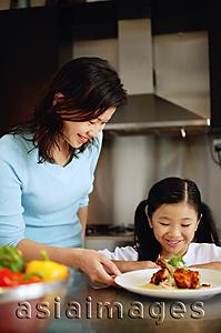 Asia Images Group -  Mother and daughter looking at plate of food