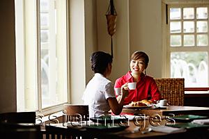Asia Images Group - Two women at cafe, having coffee