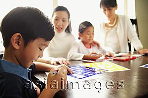 Asia Images Group - Children drawing, mother and grandmother watching