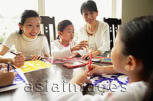 Asia Images Group - Grandmother and mother with two girls, drawing