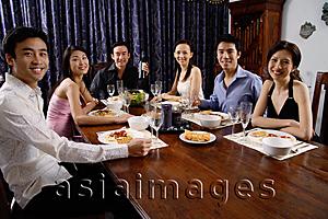 Asia Images Group - Adults sitting around table at dinner party