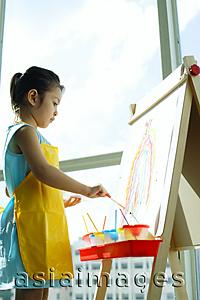 Asia Images Group - Young girl standing in front of easel, painting