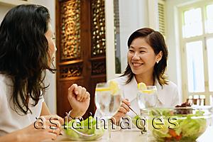 Asia Images Group - Women at a cafe, having salad lunch