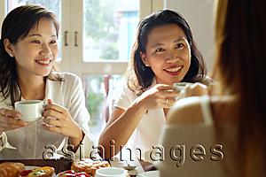 Asia Images Group - Three women sitting in cafe, having tea, over the shoulder view