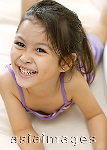 Asia Images Group - Young girl, lying down, smiling
