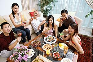 Asia Images Group - Adults sitting in living room, having a party, smiling at camera