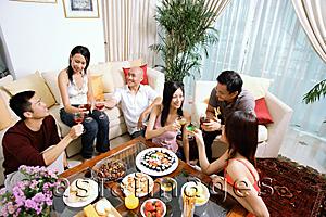 Asia Images Group - Adults sitting in living room, having a party