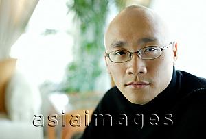 Asia Images Group - Man in black turtleneck, looking at camera, portrait