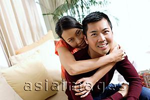 Asia Images Group - Couple at home, woman embracing man