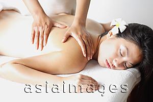 Asia Images Group - Woman with eyes closed, lying down, getting massaged