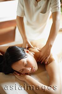 Asia Images Group - Young woman being massaged by therapist