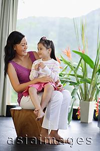 Asia Images Group - Mother with daughter on her lap