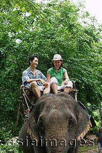 Asia Images Group - Couple riding on elephant, Phuket, Thailand