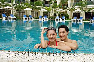 Asia Images Group - Couple in swimming pool, smiling at camera