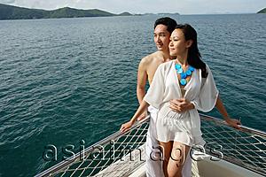 Asia Images Group - Couple standing on yacht, portrait