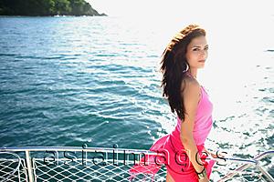 Asia Images Group - Woman on boat, standing next to railing, looking at camera