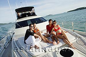 Asia Images Group - Young adults sitting on boat deck
