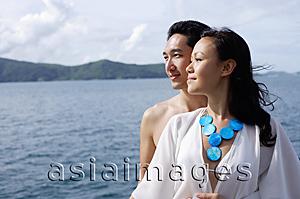 Asia Images Group - Couple standing together, cheek to cheek, looking away