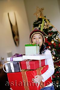 Asia Images Group - Girl carrying wrapped gift boxes