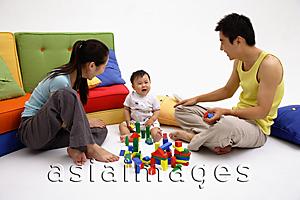 Asia Images Group - Family with one child, playing with toys, sitting on living room floor