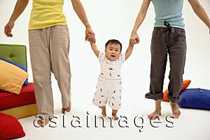 Asia Images Group - Parents holding hands with toddler