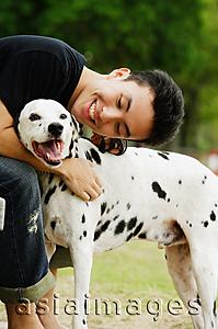 Asia Images Group - Man embracing dog