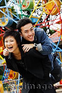 Asia Images Group - Couple at playground, looking at camera, smiling
